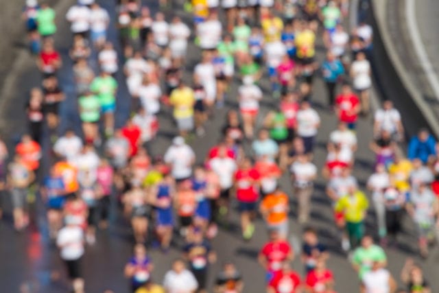 City marathon of blurred people runners